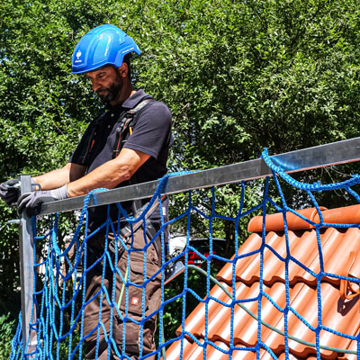 Attach safety net to guardrail of fall protection guard